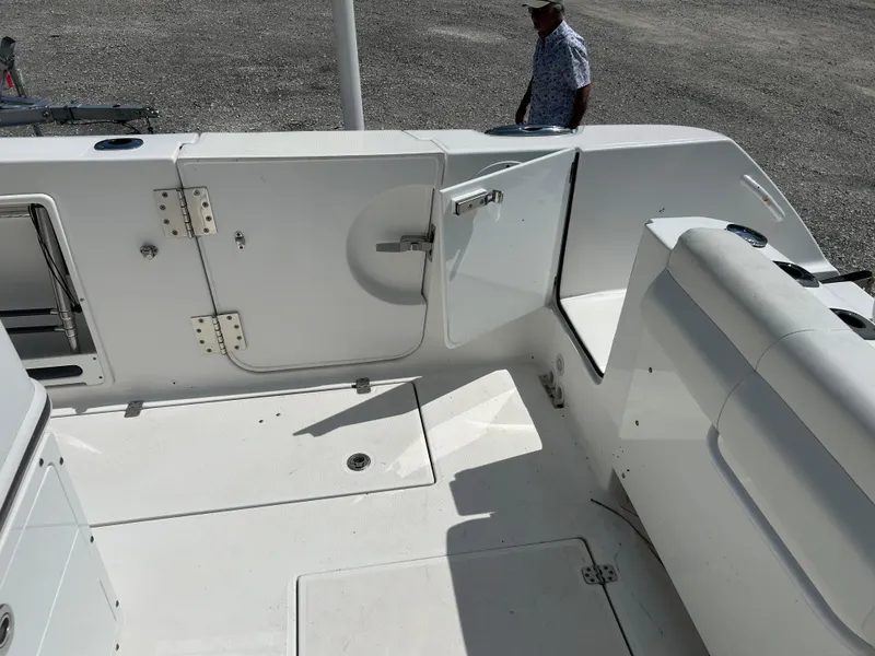 Slide: The Image of 2019 Edgewater 262CC boat interior with open hatch and seating area. - 6