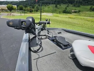 Slide: The Image of 2016 Tracker Pro Team 190 TX boat deck with trolling motor and seat, set against a scenic landscape. - 11