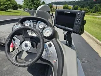 Slide: The Image of 2016 Tracker Pro Team 190 TX boat dashboard with steering wheel and electronic display. - 12