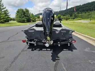 Slide: The Image of 2016 Tracker Pro Team 190 TX boat on trailer, parked on asphalt road. - 3