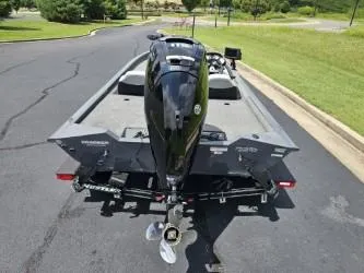 Slide: The Image of 2016 Tracker Pro Team 190 TX boat on trailer, rear view, parked on asphalt. - 4