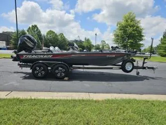 Slide: The Image of 2016 Tracker Pro Team 190 TX boat on trailer, parked outdoors under a cloudy sky. - 5