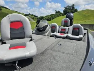 Slide: The Image of 2016 Tracker Pro Team 190 TX boat with gray and red seating on a sunny day. - 7