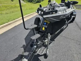 Slide: The Image of 2016 Tracker Pro Team 190 TX boat on trailer, parked on asphalt. - 8