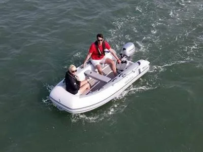 The Image of 2023 Highfield Classic 260 inflatable boat on water with two passengers. - 1