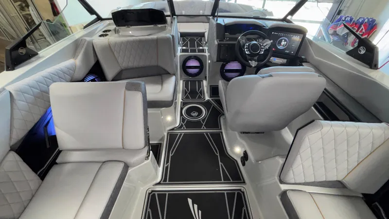 Slide: The Image of 2026 Tigé Z3 boat interior with modern seating, sleek dashboard, and stylish flooring. - 11