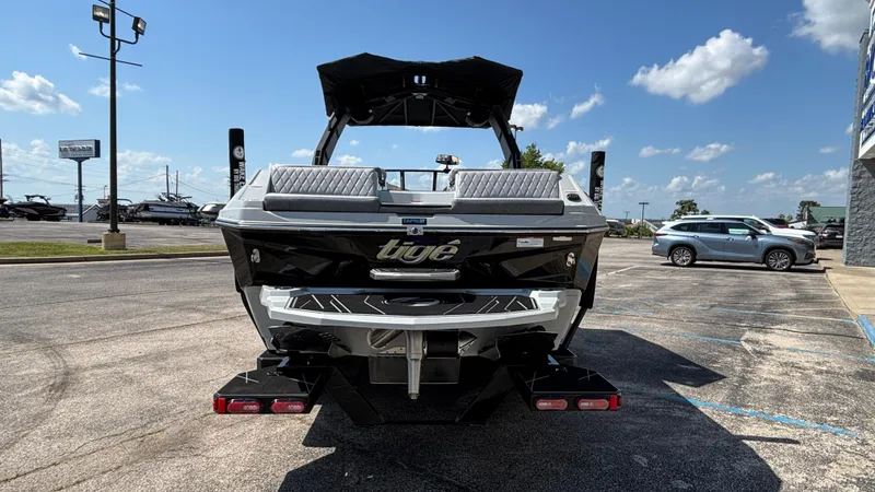 Slide: The Image of 2026 Tigé Z3 boat parked in a lot under a clear blue sky. - 2