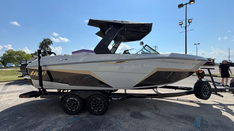 Slide: The Image of 2026 Tigé Z3 boat on trailer, parked outdoors under clear blue sky. - 3