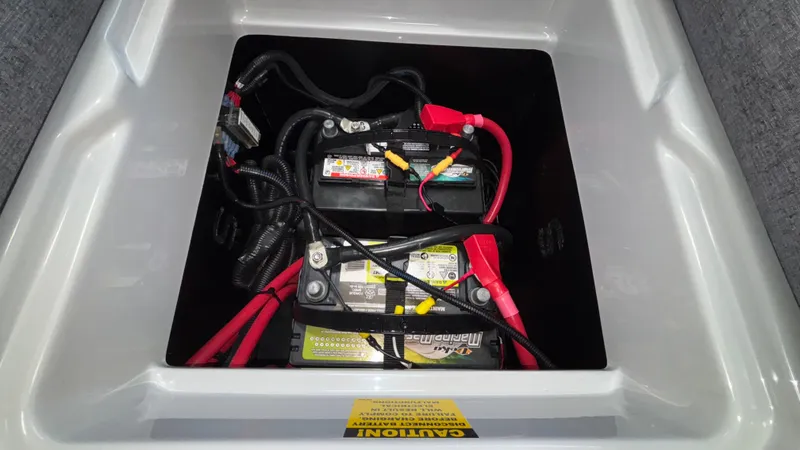 Slide: The Image of Battery compartment of 2026 Tigé Z3 boat with wiring and caution label. - 30