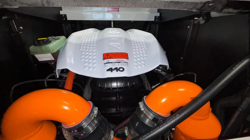Slide: The Image of Engine compartment of 2026 Tigé Z3 boat with orange components and white cover. - 43