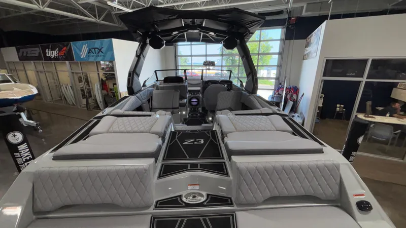 Slide: The Image of 2026 Tigé Z3 boat interior with luxurious seating and modern design in showroom. - 6