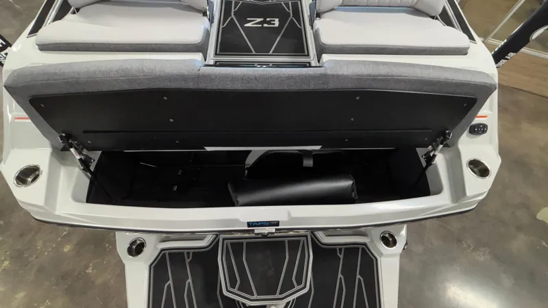 Slide: The Image of 2026 Tigé Z3 boat interior with open storage compartment and cushioned seating. - 9