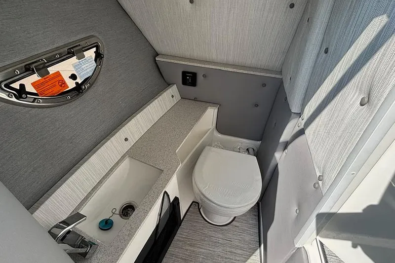 Slide: The Image of 2026 Cobalt R6 Outboard boat interior bathroom with sink and toilet. - 15