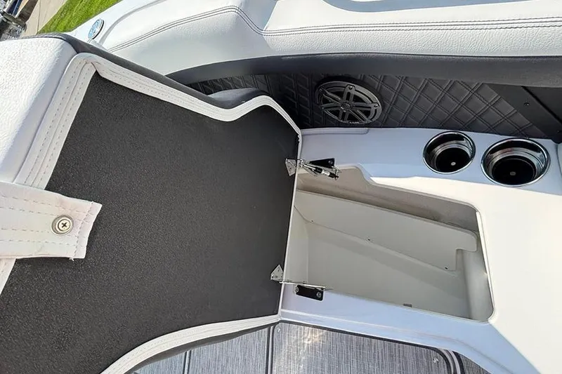 Slide: The Image of 2026 Cobalt R6 Outboard boat interior storage compartment with speaker and cup holders. - 21