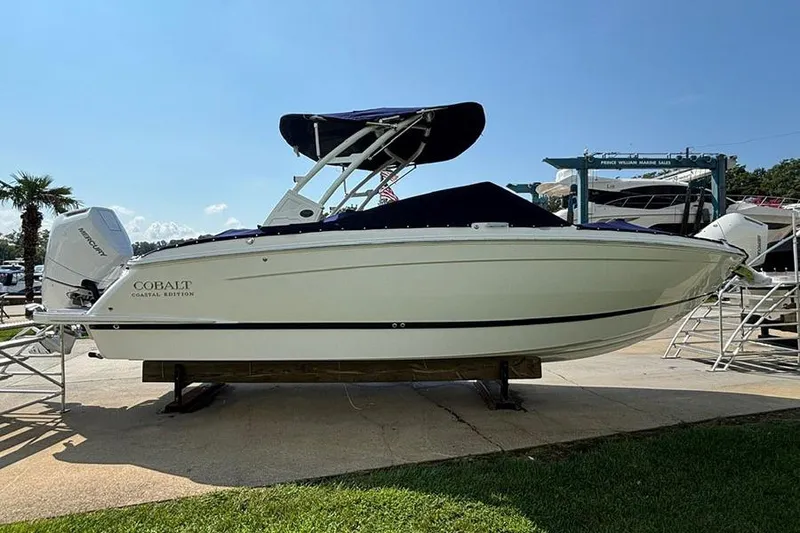 Slide: The Image of 2026 Cobalt R6 Outboard boat displayed outdoors on a sunny day. - 5