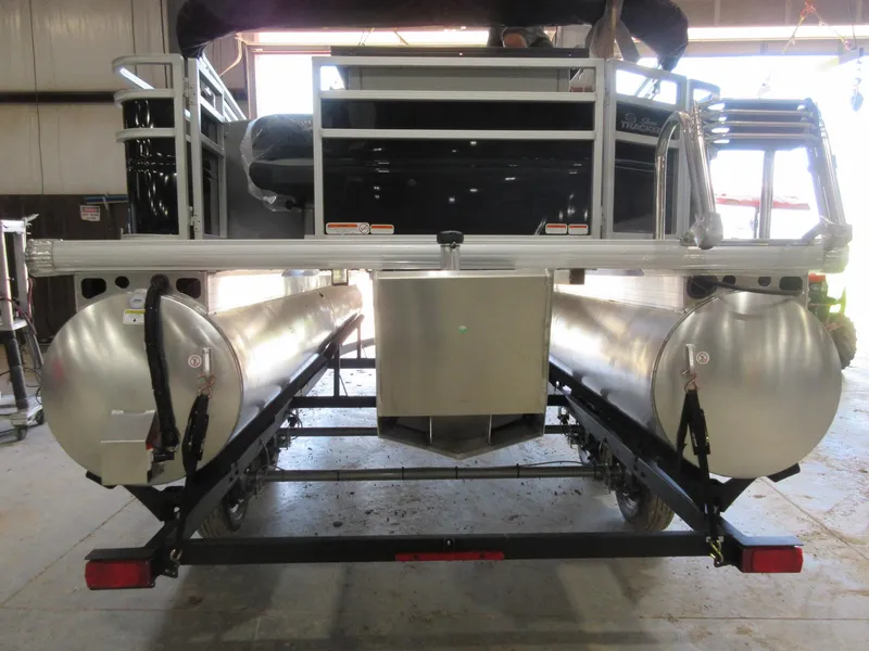 Slide: The Image of 2026 Sun Tracker SportFish 20 DLX pontoon boat rear view in a garage setting. - 3