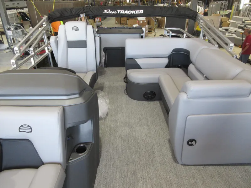 Slide: The Image of 2026 Sun Tracker SportFish 20 DLX pontoon boat interior with gray seating and spacious layout. - 4
