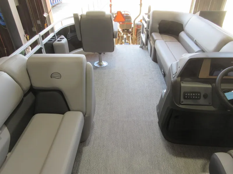 Slide: The Image of Interior of 2026 Sun Tracker SportFish 20 DLX pontoon boat with plush seating and helm. - 5