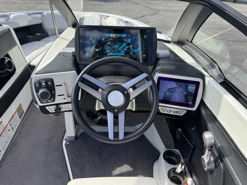 Slide: The Image of 2017 Malibu Wakesetter 20 VTX dashboard with modern controls and touchscreen displays. - 12