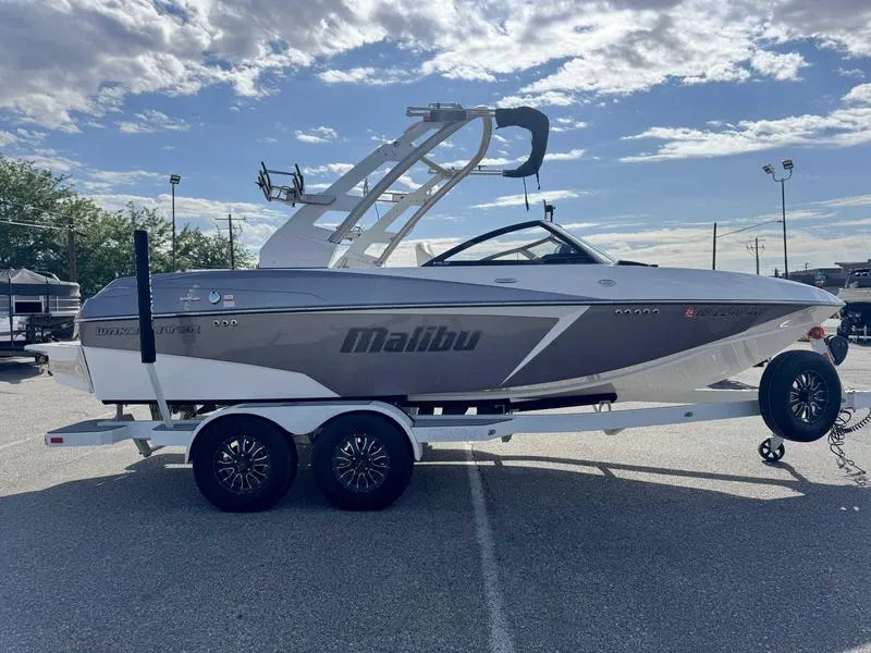 Slide: The Image of 2017 Malibu Wakesetter 20 VTX boat on trailer under a partly cloudy sky. - 5
