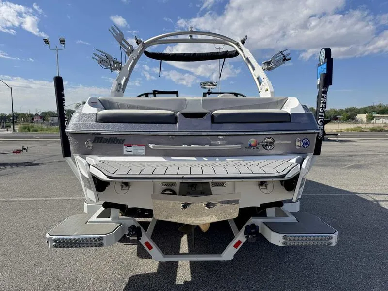 Slide: The Image of 2017 Malibu Wakesetter 20 VTX boat rear view in parking lot under blue sky. - 9