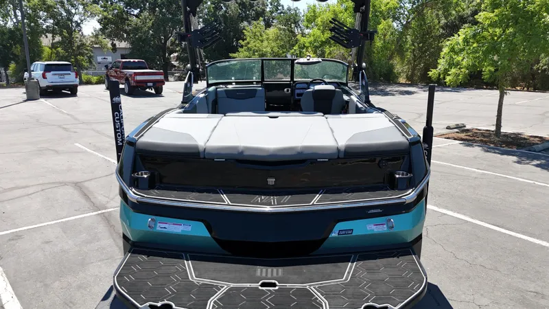 Slide: The Image of 2025 MasterCraft NXT22 boat in a parking lot, showcasing sleek design and spacious interior. - 10