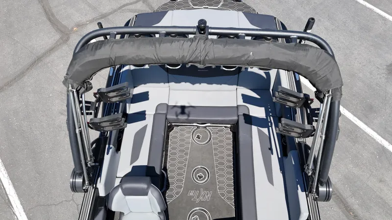 Slide: The Image of 2025 MasterCraft NXT22 boat interior with seating and wakeboard racks, viewed from above. - 13