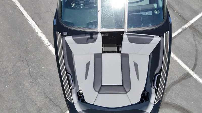 Slide: The Image of 2025 MasterCraft NXT22 boat interior, aerial view, featuring sleek gray seating design. - 16