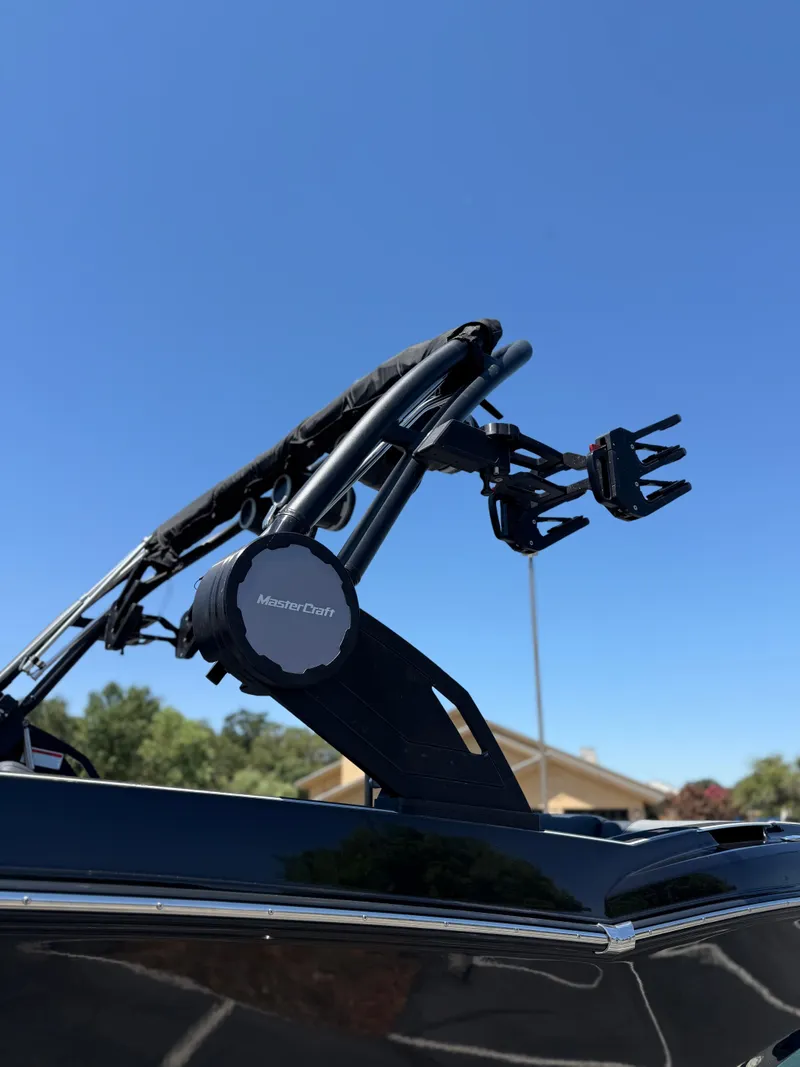 Slide: The Image of 2025 MasterCraft NXT22 boat tower against clear blue sky. - 18