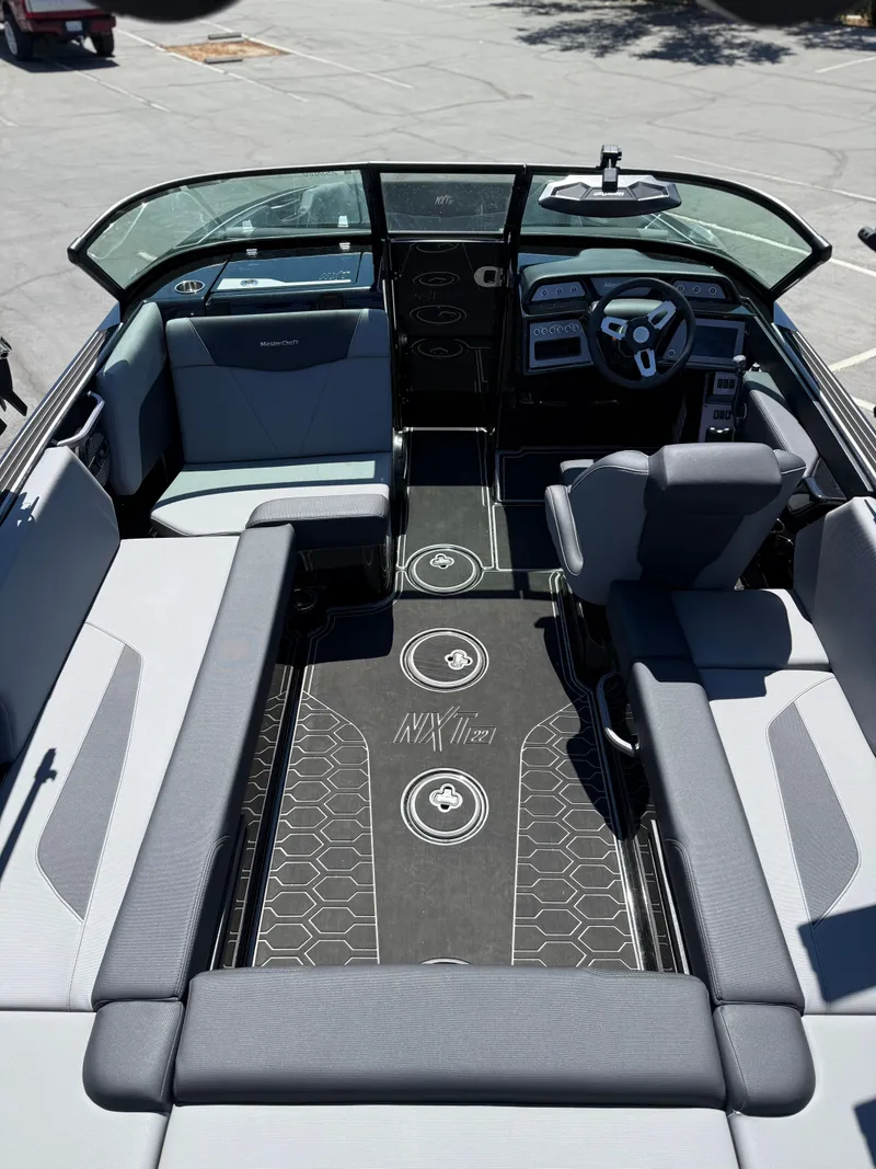 Slide: The Image of 2025 MasterCraft NXT22 boat interior with modern seating and sleek dashboard design. - 20