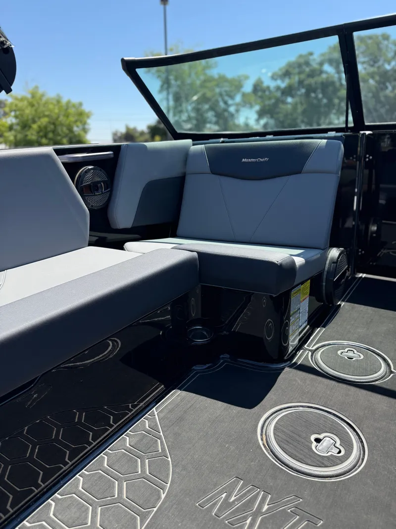 Slide: The Image of Interior of 2025 MasterCraft NXT22 boat with sleek seating and modern design. - 26