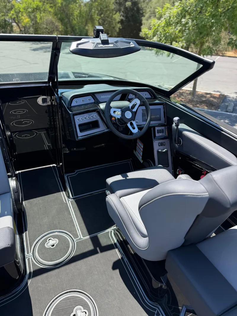 Slide: The Image of 2025 MasterCraft NXT22 boat interior with modern dashboard and steering wheel. - 28
