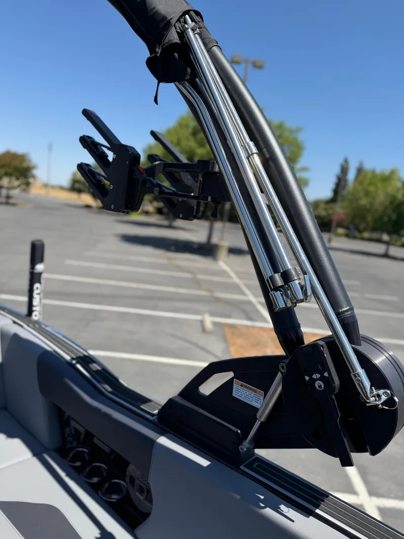 Slide: The Image of 2025 MasterCraft NXT22 boat tower detail in a parking lot. - 32