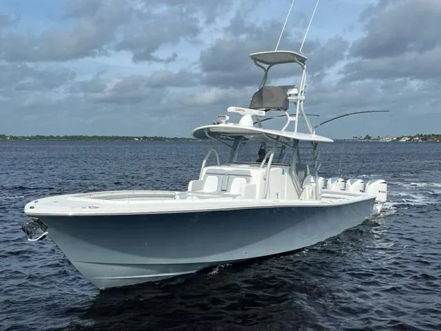 Slide: The Image of 2018 Regulator 41 boat cruising on open water under cloudy skies. - 0