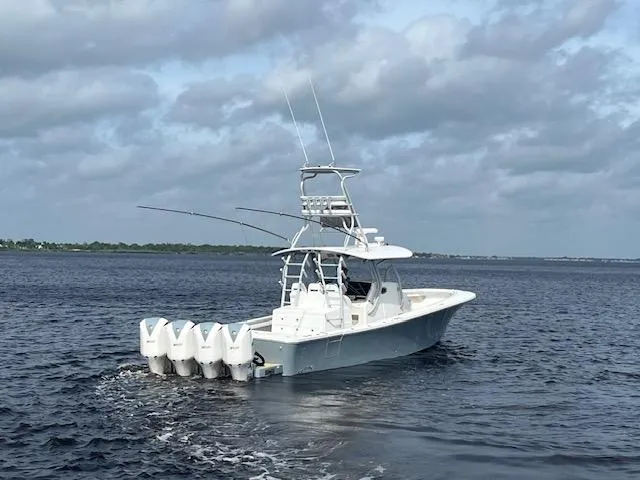 Slide: The Image of 2018 Regulator 41 boat with four engines cruising on open water under cloudy skies. - 1