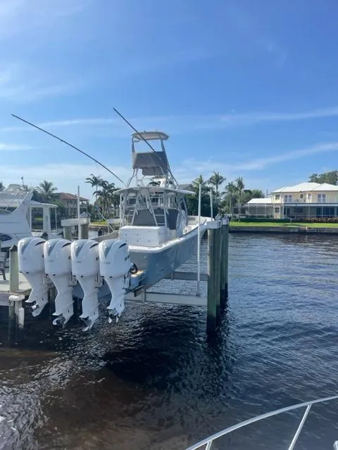 Slide: The Image of 2018 Regulator 41 boat docked with four outboard engines, under a clear blue sky. - 10