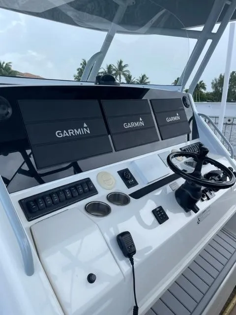 Slide: The Image of 2018 Regulator 41 boat helm with Garmin navigation displays and controls. - 12