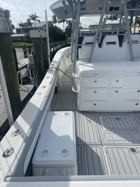 Slide: The Image of 2018 Regulator 41 boat with spacious deck and storage, docked at marina. - 16
