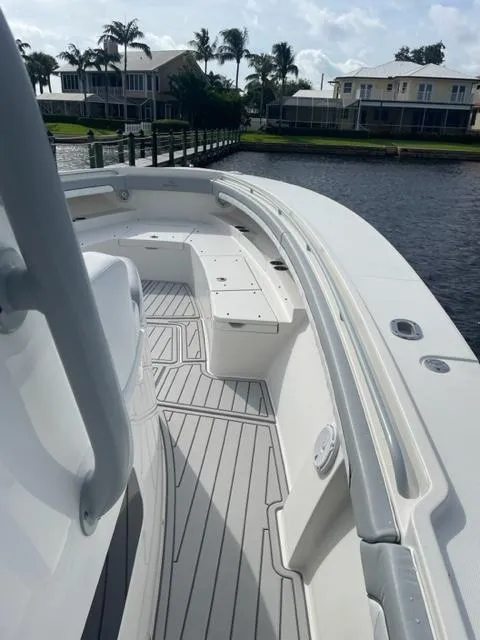 Slide: The Image of 2018 Regulator 41 boat deck with seating, docked near waterfront homes. - 19