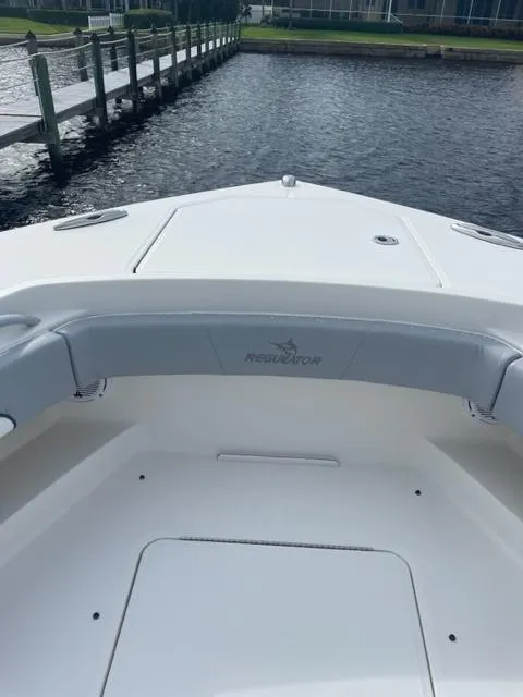 Slide: The Image of 2018 Regulator 41 boat bow with seating, docked by a wooden pier. - 20