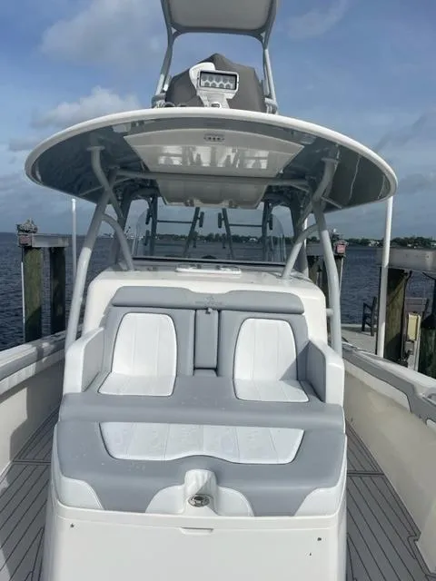 Slide: The Image of 2018 Regulator 41 boat docked, featuring spacious seating and sleek design. - 21