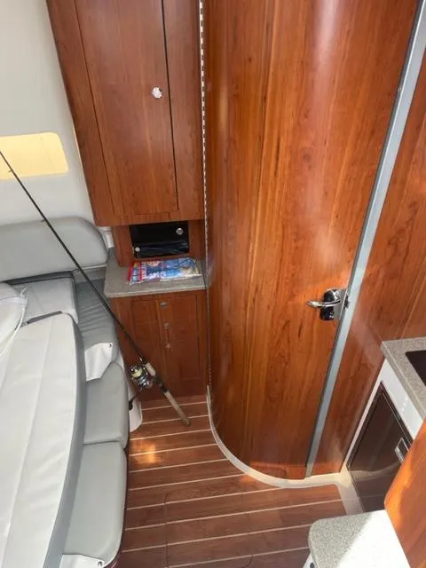 Slide: The Image of 2018 Regulator 41 interior with wood paneling, seating, and fishing rod storage. - 22
