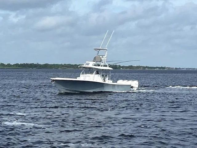 Slide: The Image of 2018 Regulator 41 boat cruising on open water under cloudy skies. - 3
