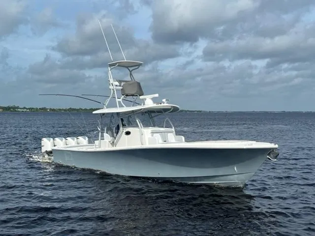 Slide: The Image of 2018 Regulator 41 boat cruising on open water under cloudy skies. - 4