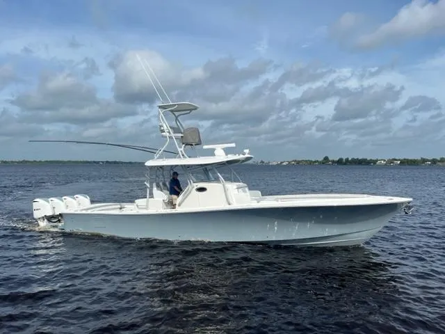 Slide: The Image of 2018 Regulator 41 boat cruising on open water under cloudy skies. - 5
