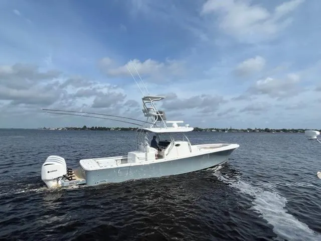 Slide: The Image of 2018 Regulator 41 boat cruising on open water under a cloudy sky. - 7