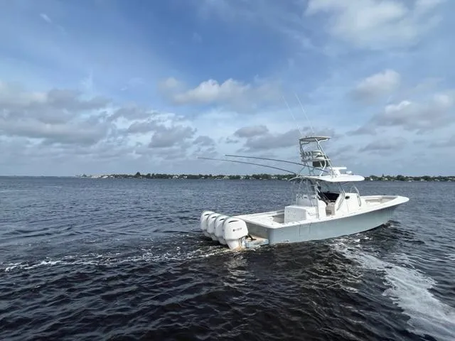 Slide: The Image of 2018 Regulator 41 boat cruising on open water under a partly cloudy sky. - 8