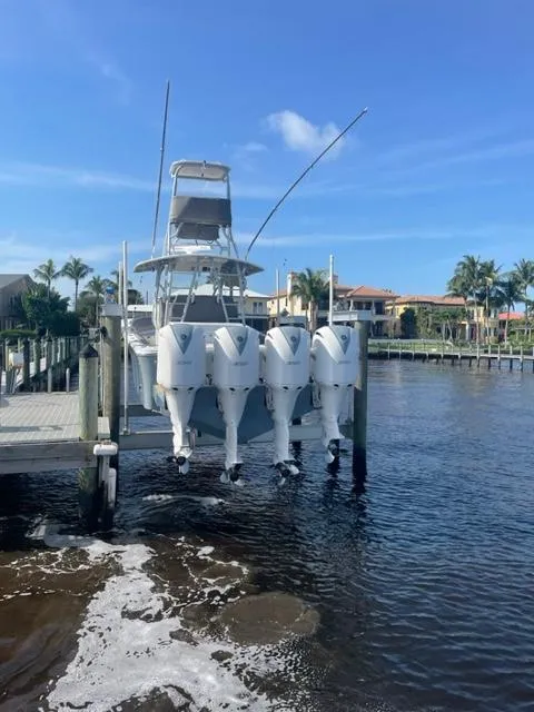 Slide: The Image of 2018 Regulator 41 boat with four engines docked by waterfront homes. - 9