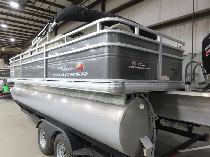 Slide: The Image of 2024 Sun Tracker Fishin' Barge 20 DLX pontoon boat in a warehouse setting. - 5