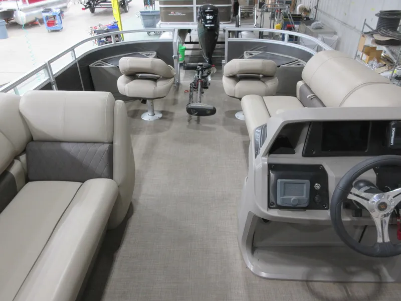 Slide: The Image of 2024 Sun Tracker Fishin' Barge 20 DLX interior with seating and steering console. - 9
